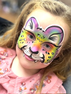 Girl with a rainbow leopard face painting in Stafford
